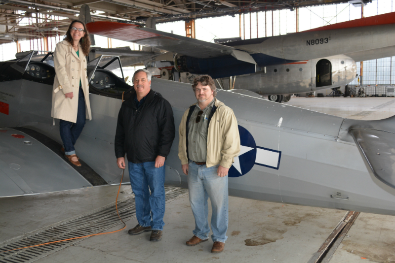 Members of Preservation Maryland, and others, pose with an airplane at Hagerstown Aviation Museum