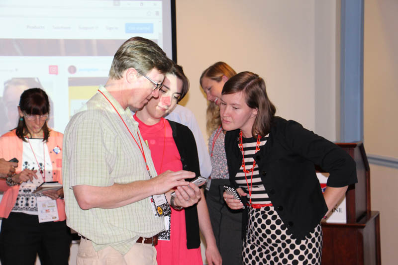 Johns Hopkins, Baltimore Heritage, Emily Huebner, and Auni Gelles (left), Heart of the Civil War Heritage Area, examining a cell phone at the social media presentation.