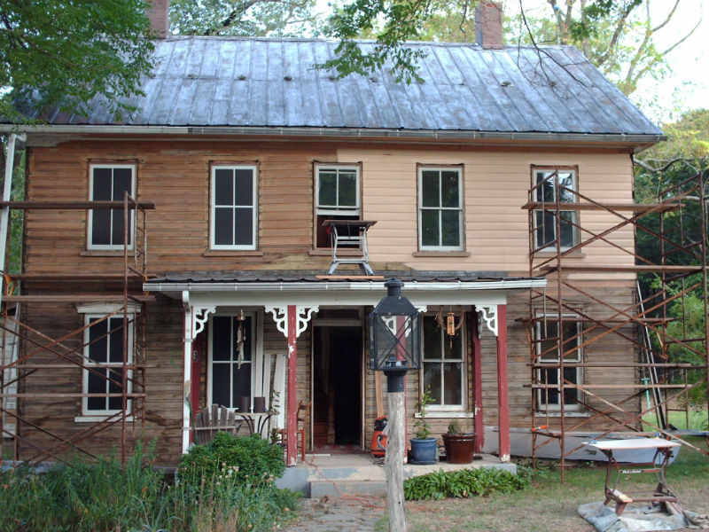 Image of historic home with construction materials