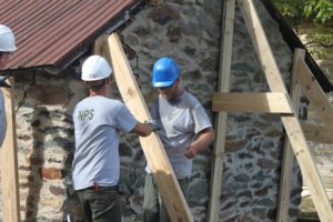 Craftsmen stabilizing a historic meat shed at Shafer Farm, 2017.