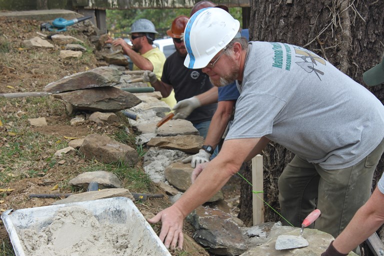 Trained masons restacking the historic stonewalls at Shafer Farm, 2017.