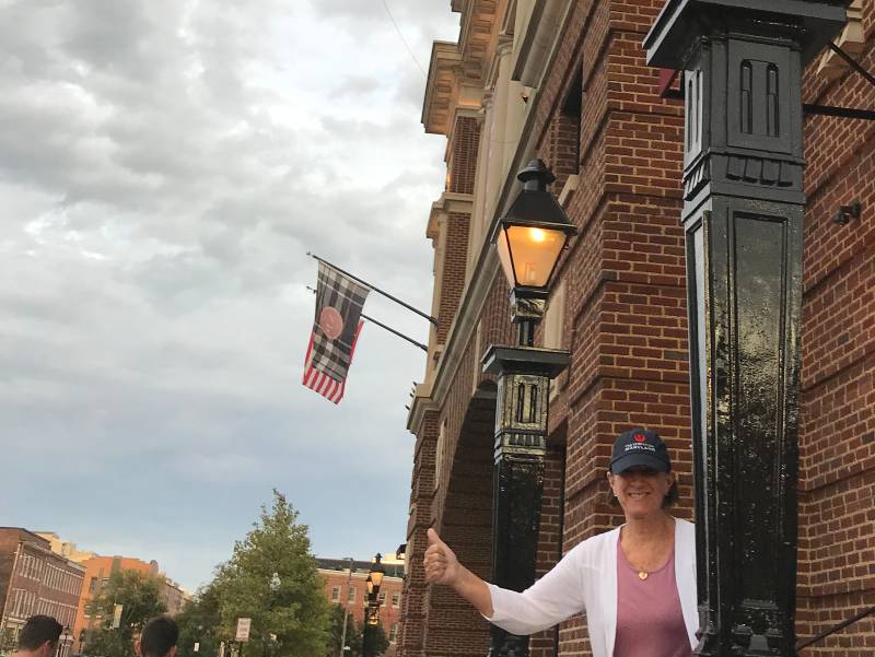 image of woman with "thumbs up" sign