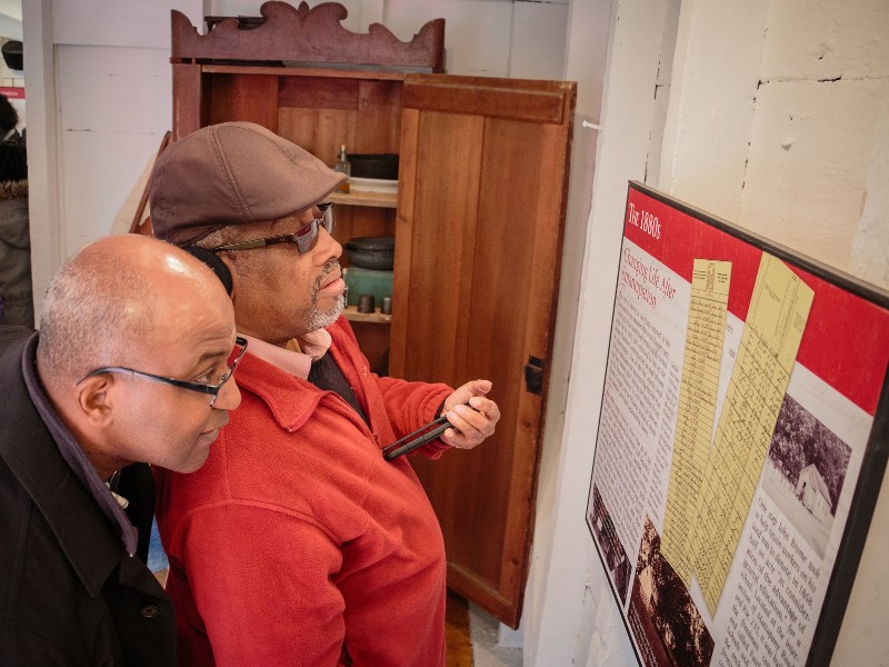 Visitors explore the Brome Slave Cabin exhibit. Photo from Historic St. Mary's City.