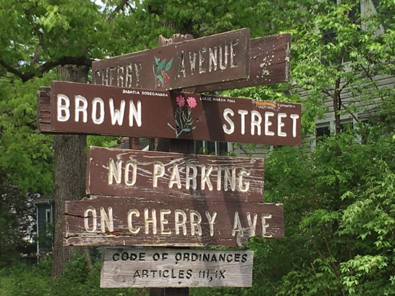 Restored sign among deteriorated signs in Washington Grove, MD, 2019.