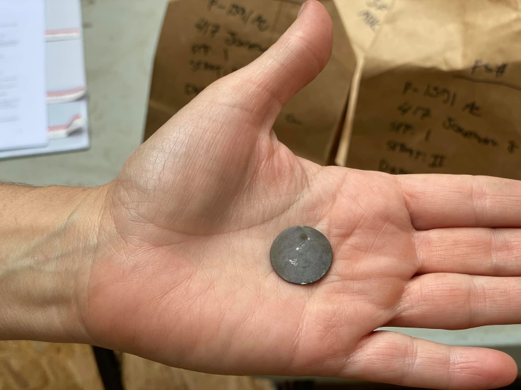 Pierced dime located in Jonathan Street excavation, 2020. 