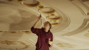 A National Park Service employee skilled in the traditional trades works to restore the ceiling in historic Ford's Theatre