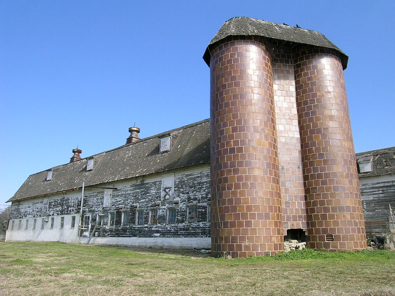 The dairy barn at Mulberry Hill Farm. The silos are covered in tile. The main house was restored and moved at some point to Easton.