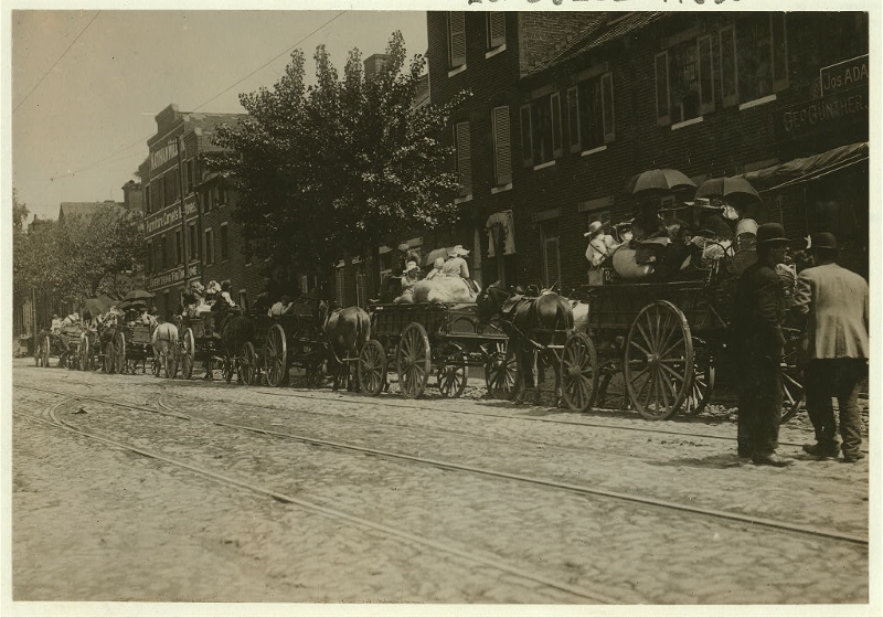 A street full of Baltimore immigrants lined up and ready to start for the country to the berry farms. Library of Congress. 